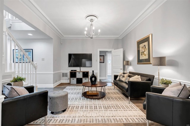 living area featuring a chandelier, wood finished floors, stairs, ornamental molding, and baseboards