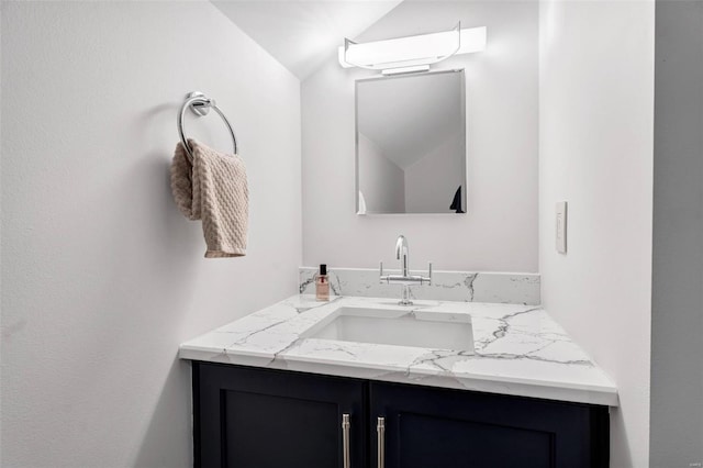 bathroom with vanity and vaulted ceiling