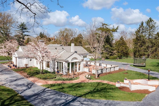view of front of home featuring a front yard and a chimney