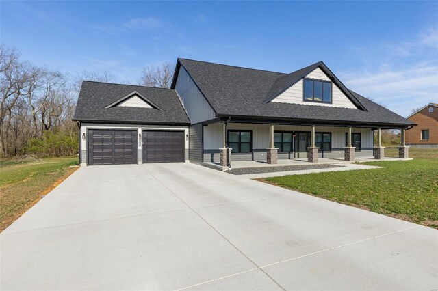 213 Lakeview Dr, Farmington, MO 63640 - view of front of house featuring an attached garage, board and batten siding, covered porch, a front yard, and roof with shingles