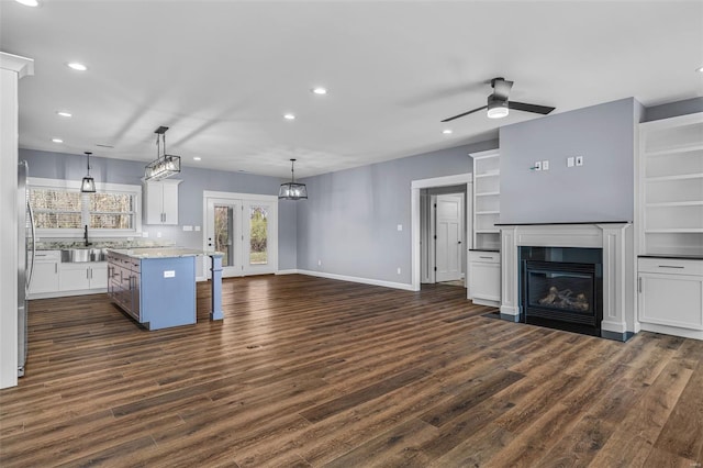 213 Lakeview Dr, Farmington, MO 63640 - kitchen with a sink, recessed lighting, white cabinetry, a fireplace with flush hearth, and dark wood-style floors