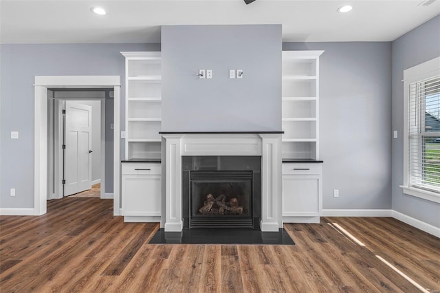 213 Lakeview Dr, Farmington, MO 63640 - unfurnished living room with dark wood-type flooring, baseboards, a fireplace with flush hearth, and recessed lighting