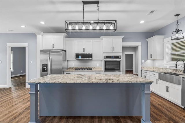 213 Lakeview Dr, Farmington, MO 63640 - kitchen with stainless steel appliances, a sink, decorative backsplash, white cabinetry, and a center island