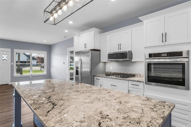 213 Lakeview Dr, Farmington, MO 63640 - kitchen with appliances with stainless steel finishes, a center island, backsplash, recessed lighting, and white cabinets