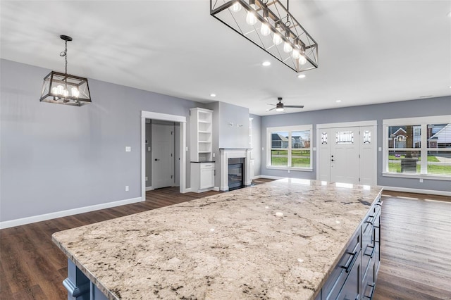 213 Lakeview Dr, Farmington, MO 63640 - unfurnished living room with baseboards, a chandelier, a glass covered fireplace, dark wood finished floors, and recessed lighting