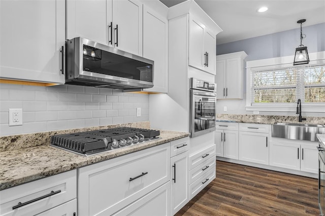 213 Lakeview Dr, Farmington, MO 63640 - kitchen with stainless steel appliances, a sink, white cabinetry, light stone counters, and recessed lighting