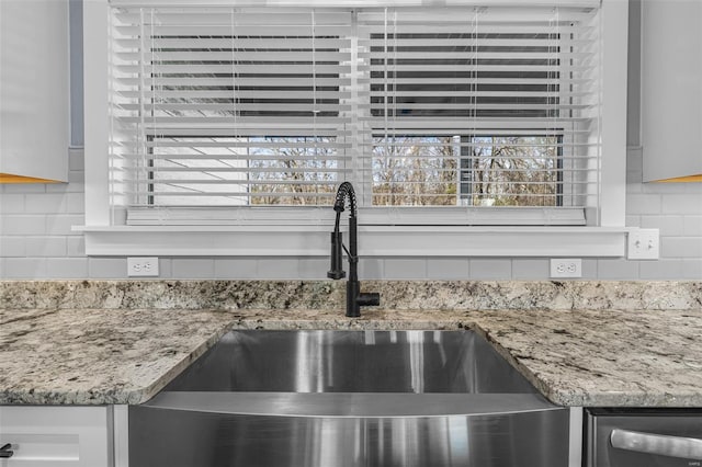213 Lakeview Dr, Farmington, MO 63640 - kitchen view of a sink, tasteful backsplash, and light stone counters