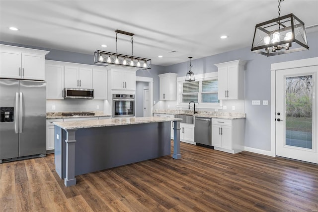 213 Lakeview Dr, Farmington, MO 63640 - kitchen featuring appliances with stainless steel finishes, a center island, backsplash, white cabinets, and recessed lighting
