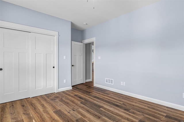 213 Lakeview Dr, Farmington, MO 63640 - unfurnished bedroom with baseboards, dark wood-type flooring, and a closet