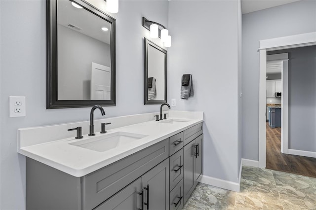 213 Lakeview Dr, Farmington, MO 63640 - bathroom with baseboards, double vanity, and marble finish flooring