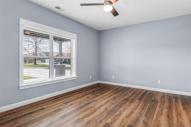 213 Lakeview Dr, Farmington, MO 63640 - spare room with healthy amount of natural light, ceiling fan, baseboards, and dark wood-type flooring