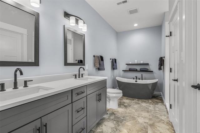 213 Lakeview Dr, Farmington, MO 63640 - full bathroom featuring a freestanding tub, double vanity, baseboards, and toilet