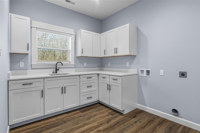 213 Lakeview Dr, Farmington, MO 63640 - clothes washing area featuring hookup for an electric dryer, washer hookup, dark wood-style floors, baseboards, and cabinet space