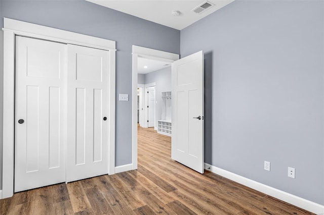 213 Lakeview Dr, Farmington, MO 63640 - unfurnished bedroom featuring baseboards, wood finished floors, and a closet