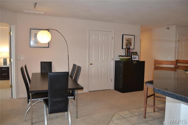 dining space featuring carpet