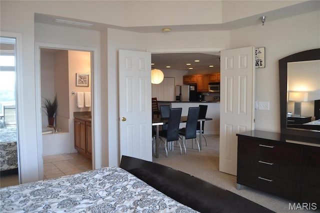 bedroom featuring refrigerator, light tile patterned floors, ensuite bathroom, and recessed lighting