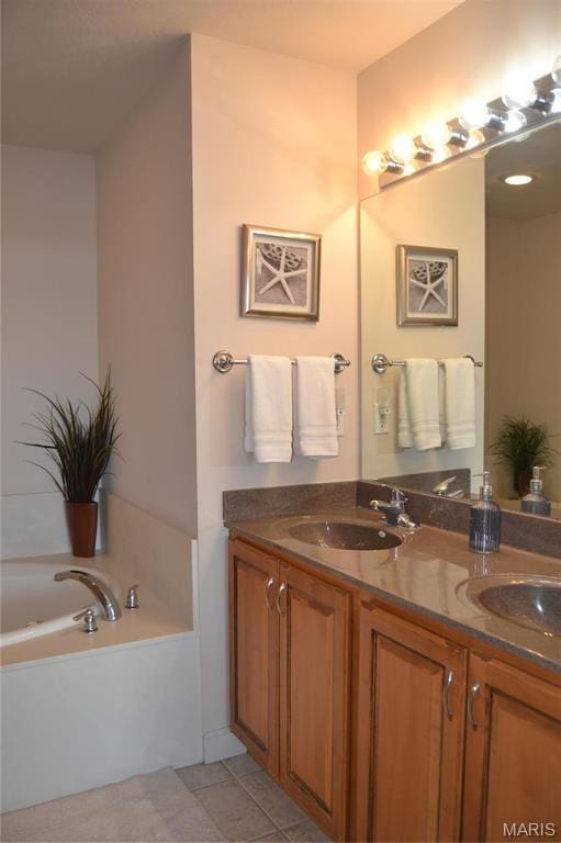 full bath featuring double vanity, a bath, and tile patterned floors