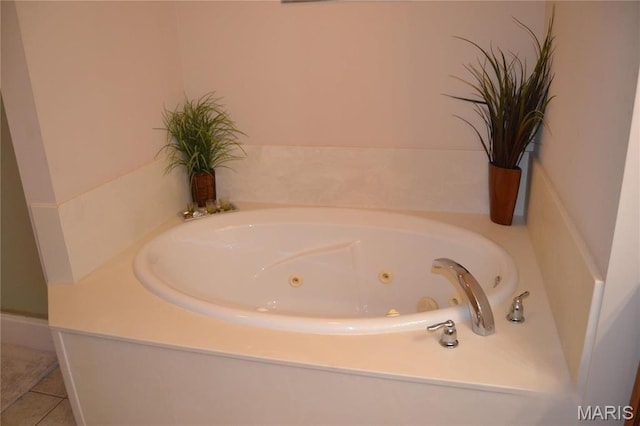 full bath featuring a tub with jets and tile patterned flooring