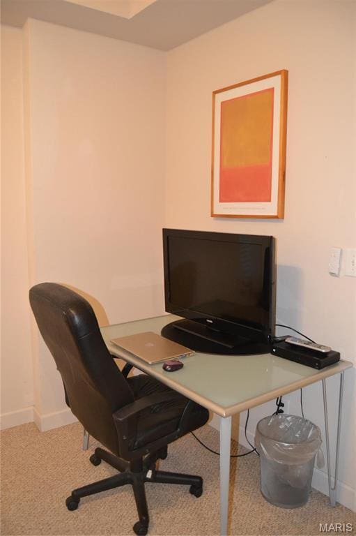 carpeted office featuring baseboards