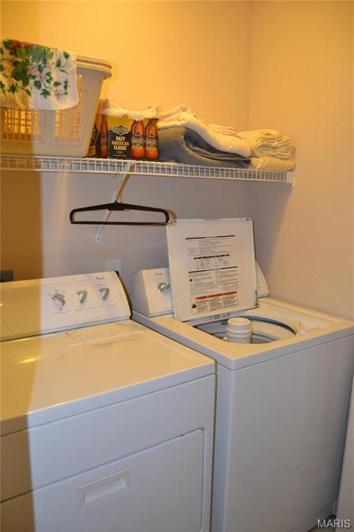 laundry area with washing machine and clothes dryer
