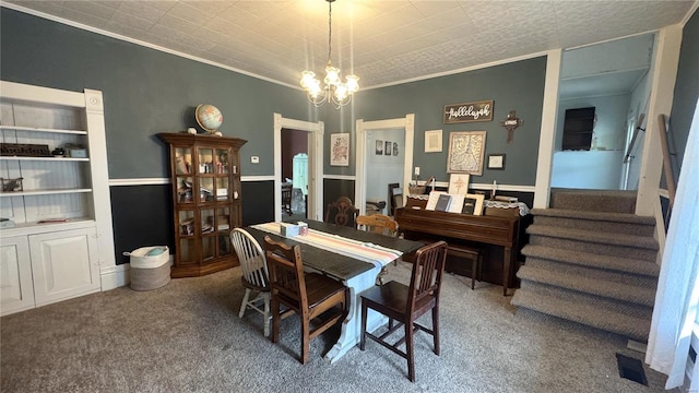 dining room with carpet, a chandelier, ornamental molding, and stairs