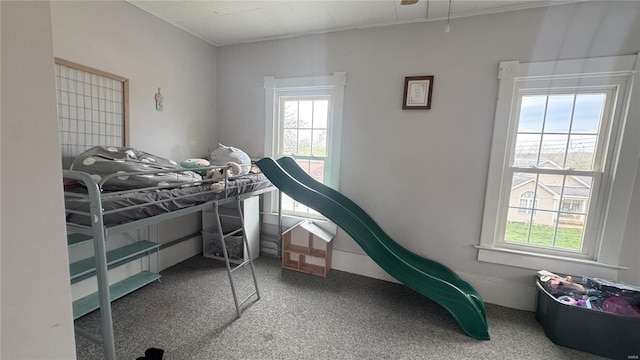bedroom featuring multiple windows, carpet, and crown molding