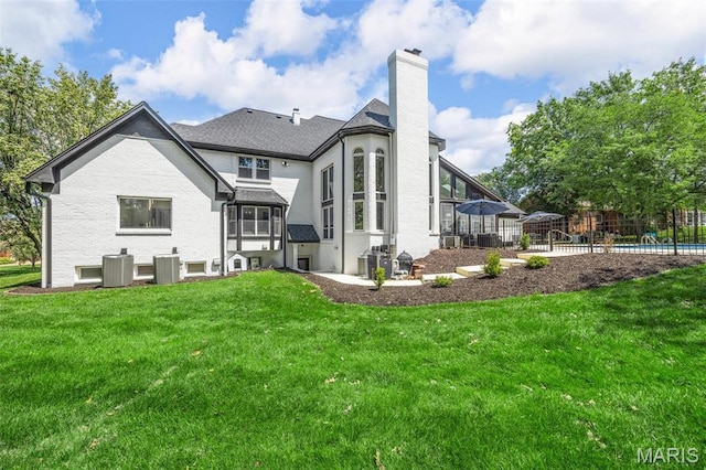 13516 Weston Park Dr, Saint Louis, MO 63131 - back of house featuring a chimney and central AC