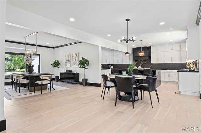 13516 Weston Park Dr, Saint Louis, MO 63131 - dining room featuring a chandelier, recessed lighting, light wood finished floors, and baseboards