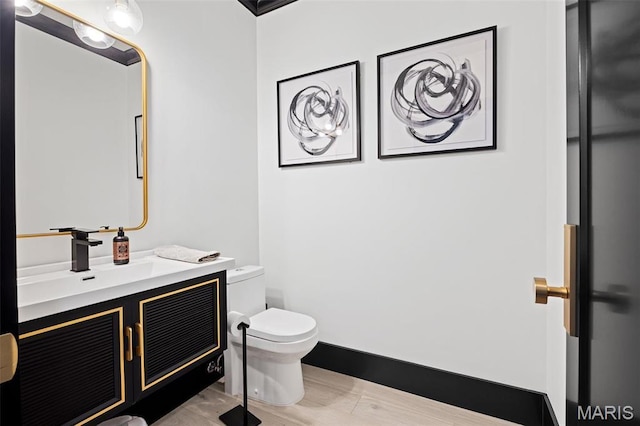 13516 Weston Park Dr, Saint Louis, MO 63131 - half bath with toilet, vanity, wood finished floors, and baseboards