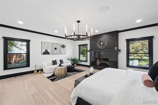 13516 Weston Park Dr, Saint Louis, MO 63131 - bedroom featuring a chandelier, crown molding, recessed lighting, wood finished floors, and a fireplace