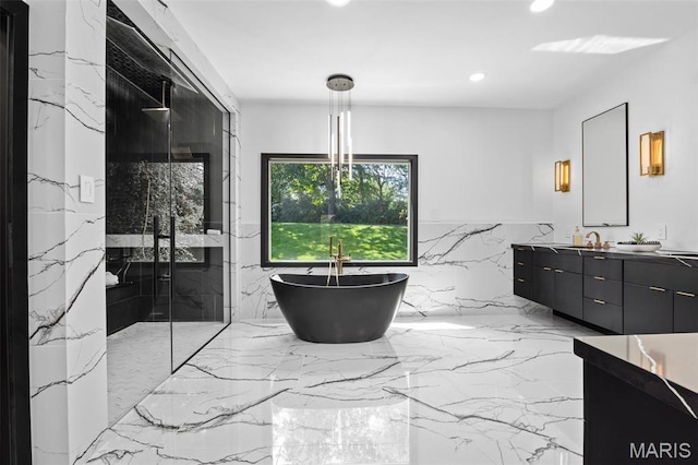 13516 Weston Park Dr, Saint Louis, MO 63131 - full bathroom featuring recessed lighting, a marble finish shower, double vanity, a freestanding tub, and marble tiled floors