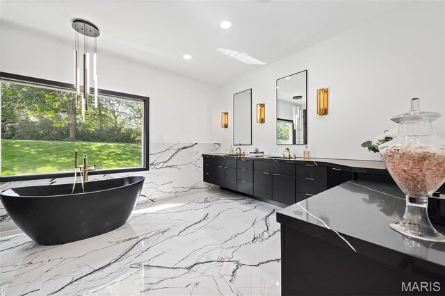13516 Weston Park Dr, Saint Louis, MO 63131 - full bathroom with recessed lighting, double vanity, a soaking tub, and marble tiled floors