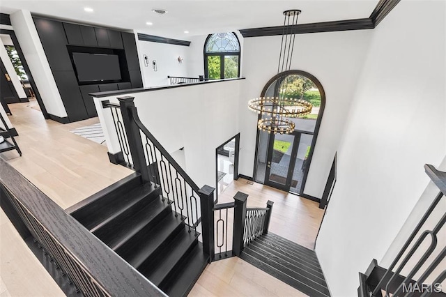 13516 Weston Park Dr, Saint Louis, MO 63131 - staircase with a chandelier, wood finished floors, recessed lighting, baseboards, and a high ceiling