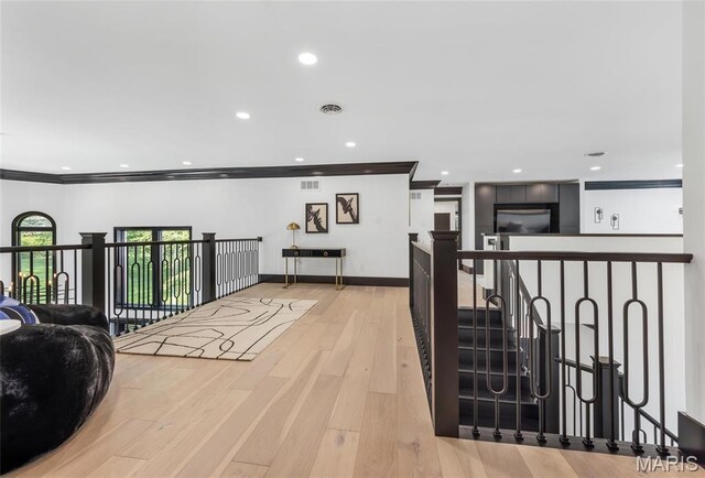 13516 Weston Park Dr, Saint Louis, MO 63131 - hallway with crown molding, an upstairs landing, light wood-style floors, and recessed lighting