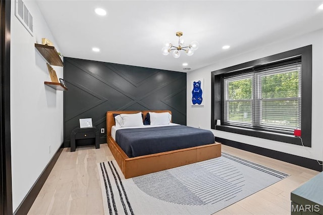 13516 Weston Park Dr, Saint Louis, MO 63131 - bedroom with a chandelier, a decorative wall, baseboards, light wood-style floors, and recessed lighting