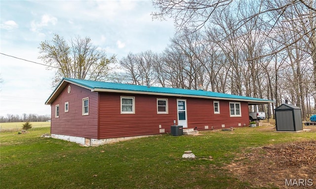 4434 County Road 4110, Salem, MO 65560 - back of house featuring a storage shed, an outbuilding, a lawn, and central air condition unit