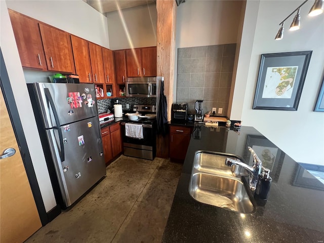 1113 Washington Ave Unit 510, Saint Louis, MO 63101 - kitchen featuring stainless steel appliances, a sink, backsplash, concrete floors, and brown cabinets