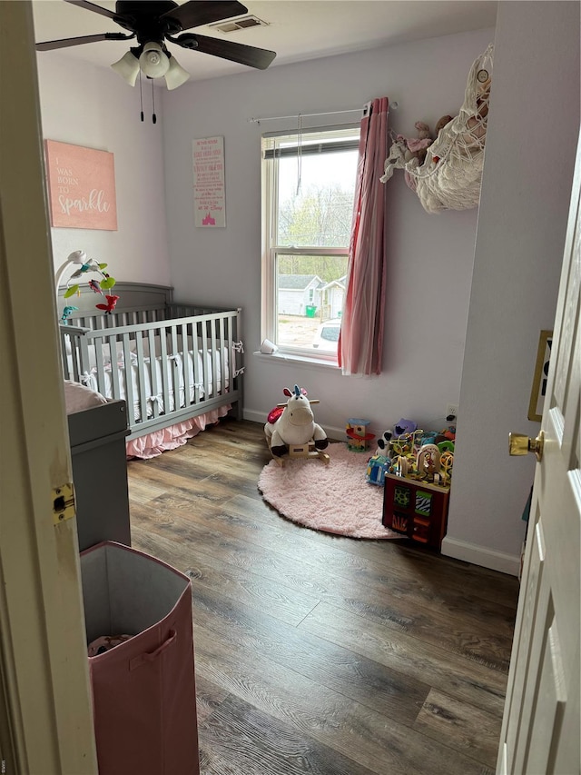 16 Wood St, Park Hills, MO 63601 - bedroom featuring a crib, wood finished floors, baseboards, and a ceiling fan