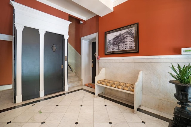 4 N Kingshighway Blvd Unit 4D, Saint Louis, MO 63108 - interior space featuring a wainscoted wall, inlaid floor details, stairs, and tile patterned flooring