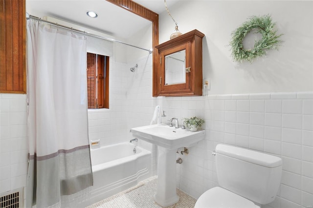 4 N Kingshighway Blvd Unit 4D, Saint Louis, MO 63108 - bathroom featuring tile walls, toilet, shower / bath combination with curtain, tile patterned flooring, and wainscoting