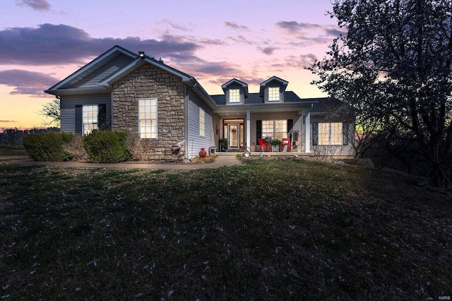 21933 Pike 215, Annada, MO 63330 - view of front of house with stone siding, a porch, and a front yard
