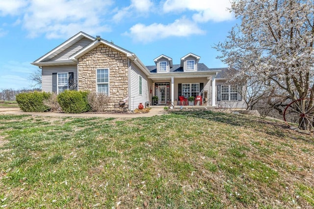 21933 Pike 215, Annada, MO 63330 - view of front of home with a front yard, stone siding, and covered porch