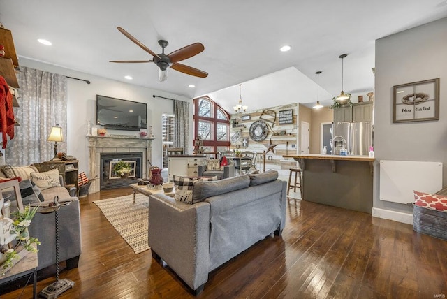21933 Pike 215, Annada, MO 63330 - living area with ceiling fan, a glass covered fireplace, dark wood-style floors, recessed lighting, and lofted ceiling