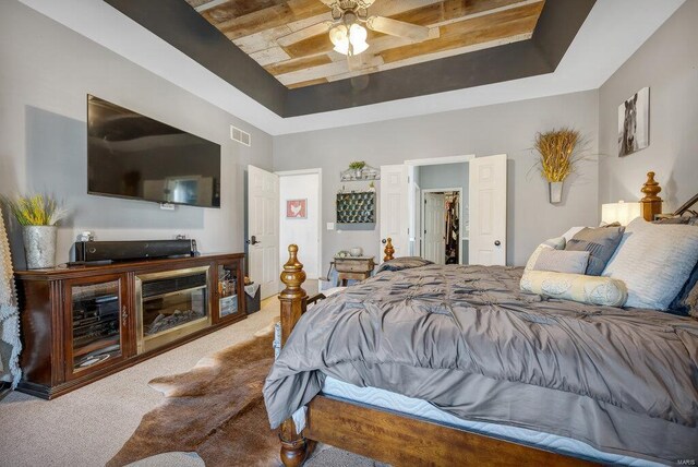 21933 Pike 215, Annada, MO 63330 - carpeted bedroom with a raised ceiling, a spacious closet, a ceiling fan, and a closet