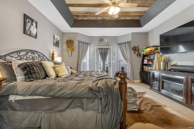 21933 Pike 215, Annada, MO 63330 - carpeted bedroom featuring a tray ceiling, access to exterior, a ceiling fan, and wood ceiling