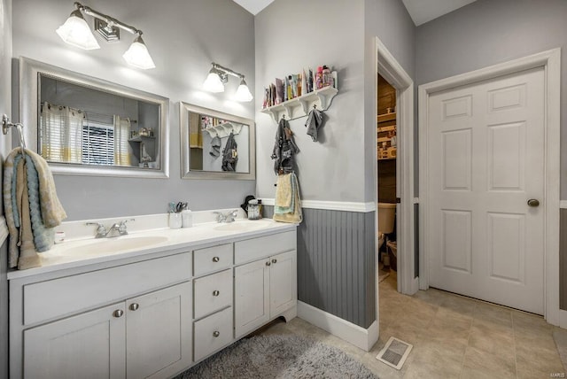 21933 Pike 215, Annada, MO 63330 - full bathroom with double vanity, a wainscoted wall, and toilet