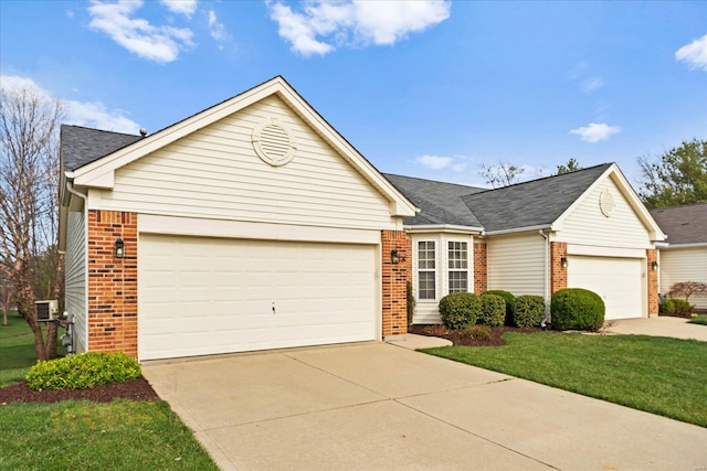 1719 Ambrose Terrace Dr, Swansea, IL 62226 - view of front facade featuring brick siding, an attached garage, driveway, and a front lawn