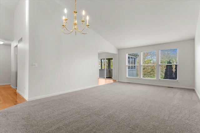 1719 Ambrose Terrace Dr, Swansea, IL 62226 - spare room featuring a chandelier, baseboards, high vaulted ceiling, and light colored carpet