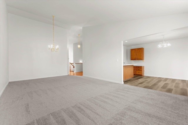 1719 Ambrose Terrace Dr, Swansea, IL 62226 - unfurnished living room featuring a chandelier, light carpet, and baseboards