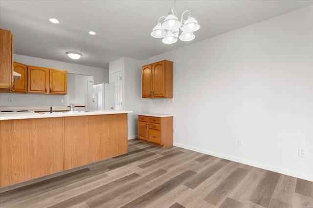 1719 Ambrose Terrace Dr, Swansea, IL 62226 - kitchen with white fridge with ice dispenser, light wood-style flooring, light countertops, baseboards, and recessed lighting